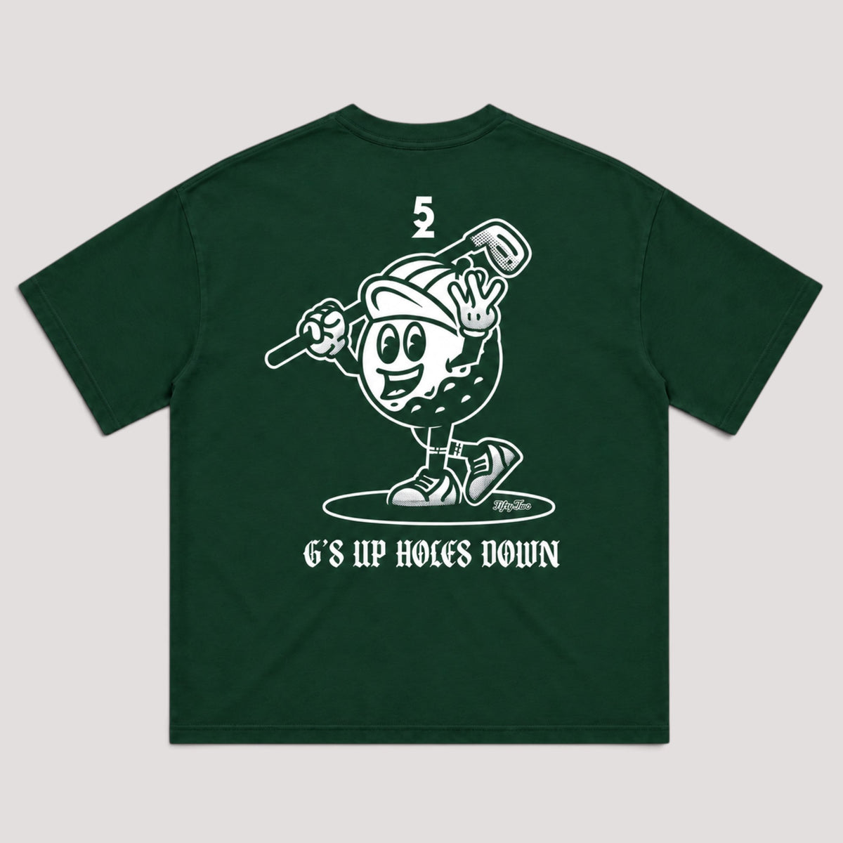 A dark green short-sleeve t-shirt with a white graphic print on the back. The graphic features a cartoon golf ball character holding a club, and the text 'G'S UP HOLES DOWN' below.