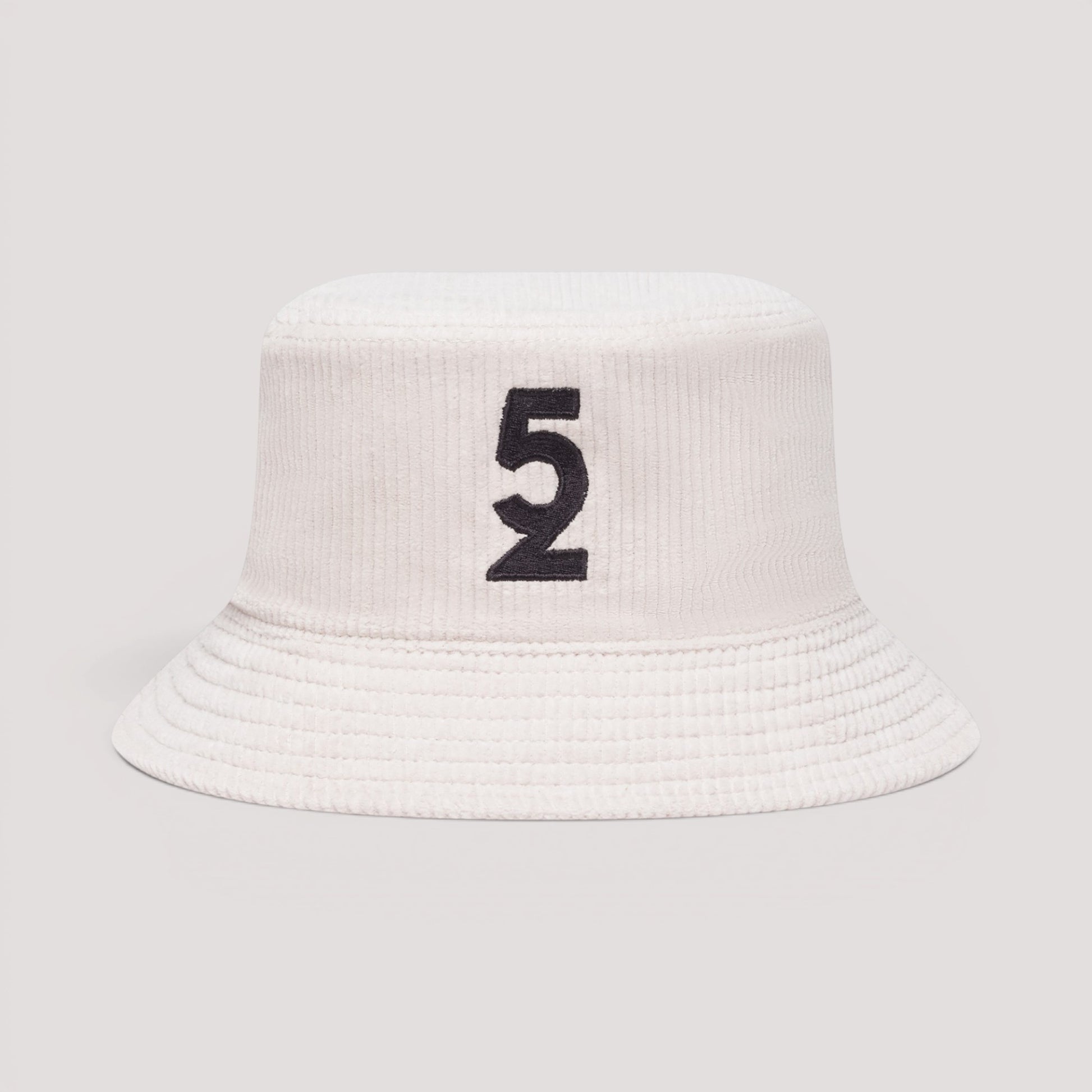 A white bucket hat made of corduroy, featuring a black embroidered number 5 on the front, set against a solid light gray background.