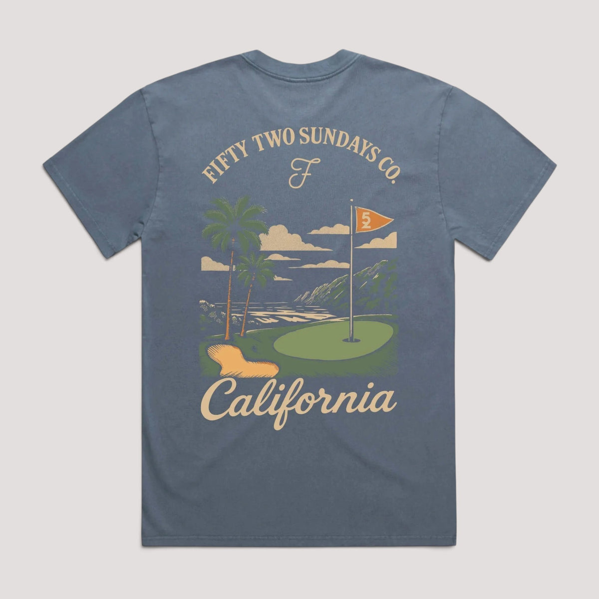A heathered slate blue t-shirt shown from the back, featuring a vintage-style graphic of a California golf course with palm trees, a green, a flag, and the text 'FIFTY TWO SUNDAYS CO.' and 'California'.
