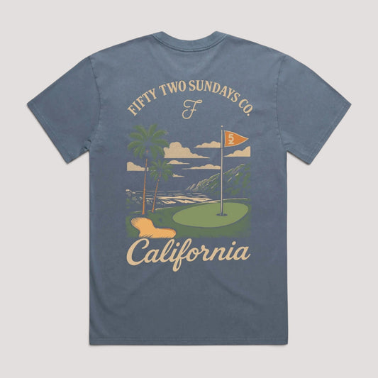 A heathered slate blue t-shirt shown from the back, featuring a vintage-style graphic of a California golf course with palm trees, a green, a flag, and the text 'FIFTY TWO SUNDAYS CO.' and 'California'.