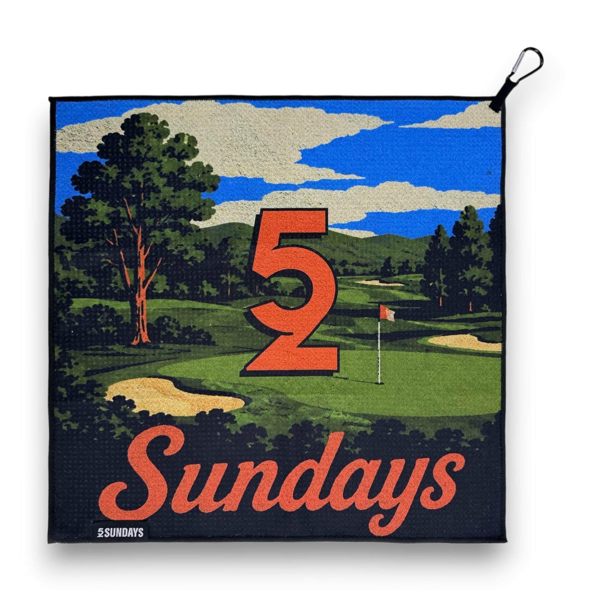 A square golf-themed towel featuring a vintage-style illustrated golf course scene with a large orange '52' and the word 'Sundays' in orange script. The design includes green grass, trees, sand bunkers, blue sky, and a black border.