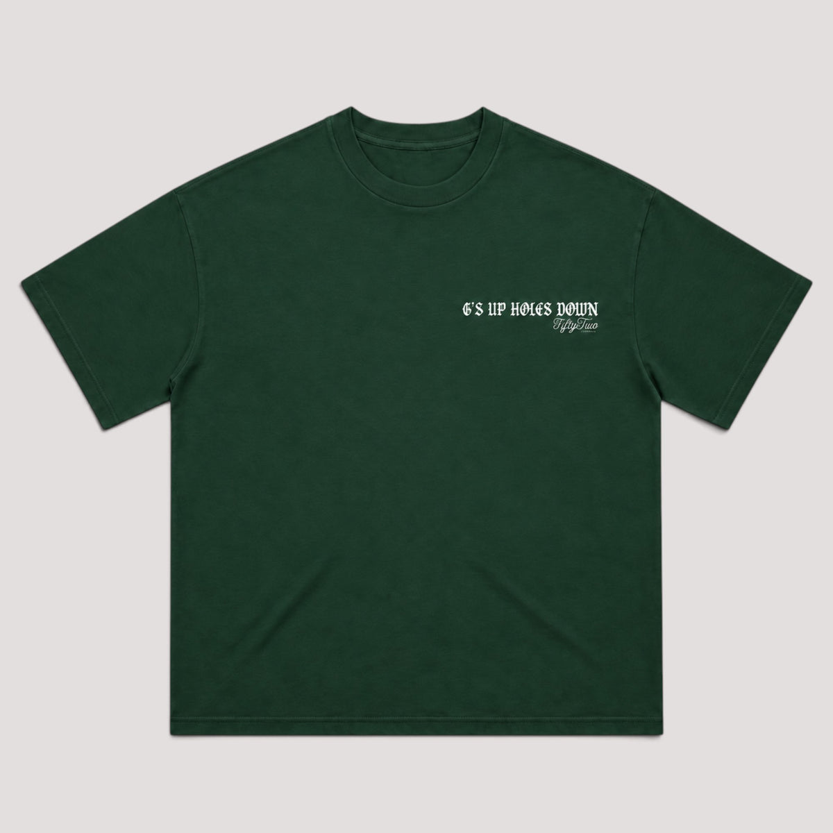 A dark green short-sleeve t-shirt with a small white graphic text print on the left chest reading 'G'5 UP HOLES DOWN' and displayed flat against a light gray background.
