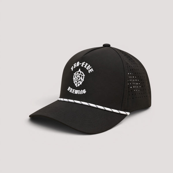 A black golf hat with white silicone logo 'PRO-FIVE BREWING' text and a white-and-black striped detail on the brim, shown against a light gray background.